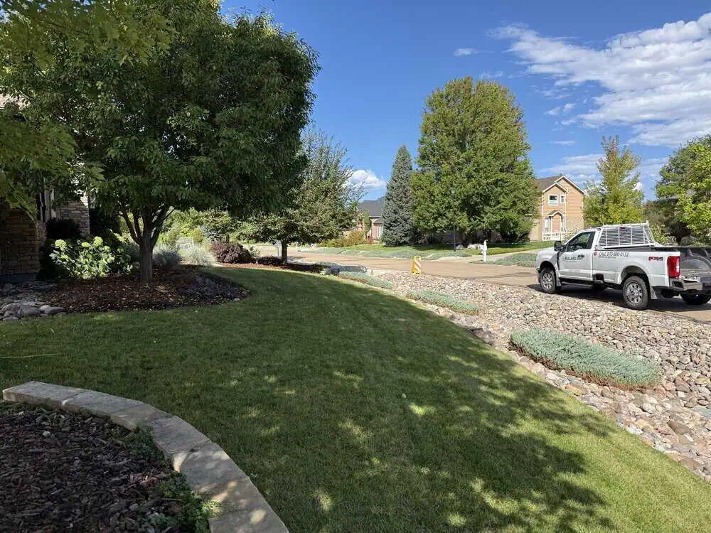 Bullard service truck at residential property with professionally maintained landscape and trees
