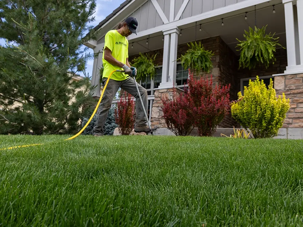 Bullard technician applying pest control treatment at residential property